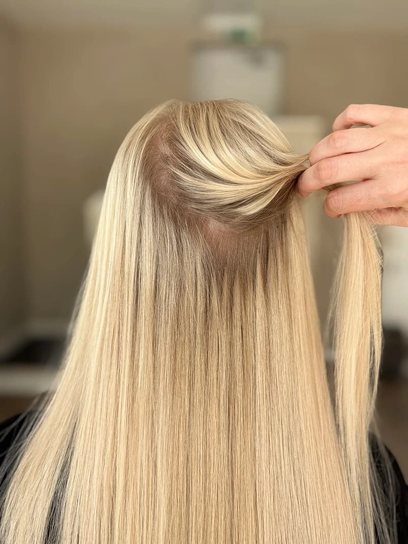 Professional keratin bond hair extensions application showing invisible bond technique