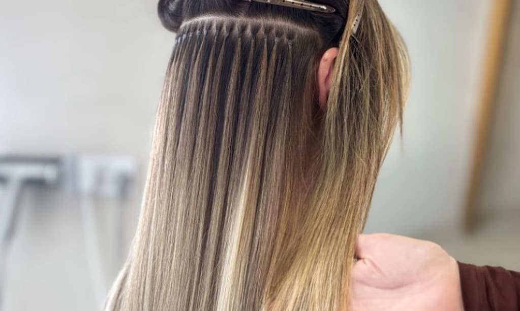 Close up of invisible micro ring hair extensions showing seamless blend