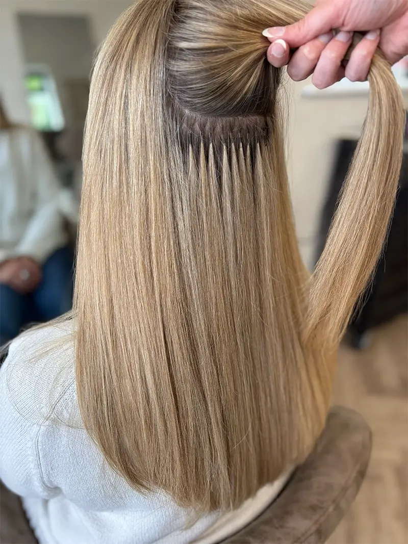 Professional micro ring hair extensions fitting process showing damage-free attachment method