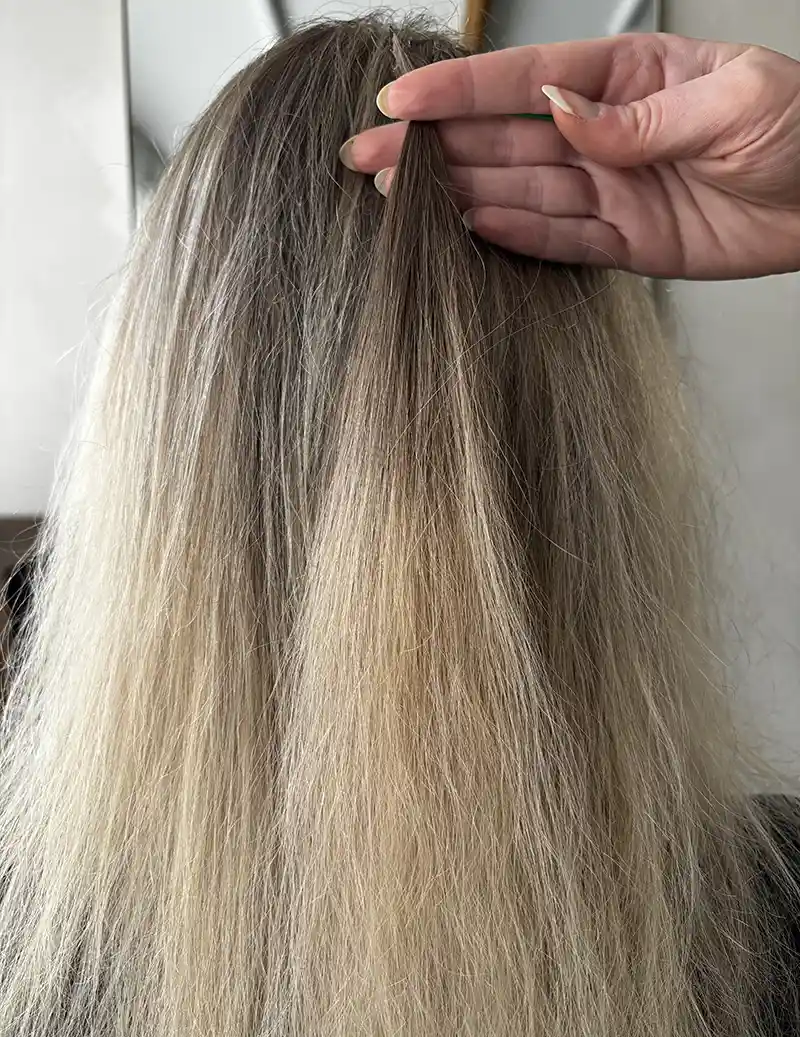 A model with curly hair extensions showing natural curl pattern matching