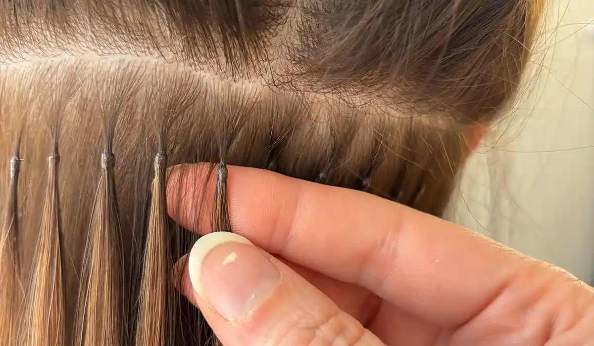 A model having keratin bond hair extensions fitted in-salon