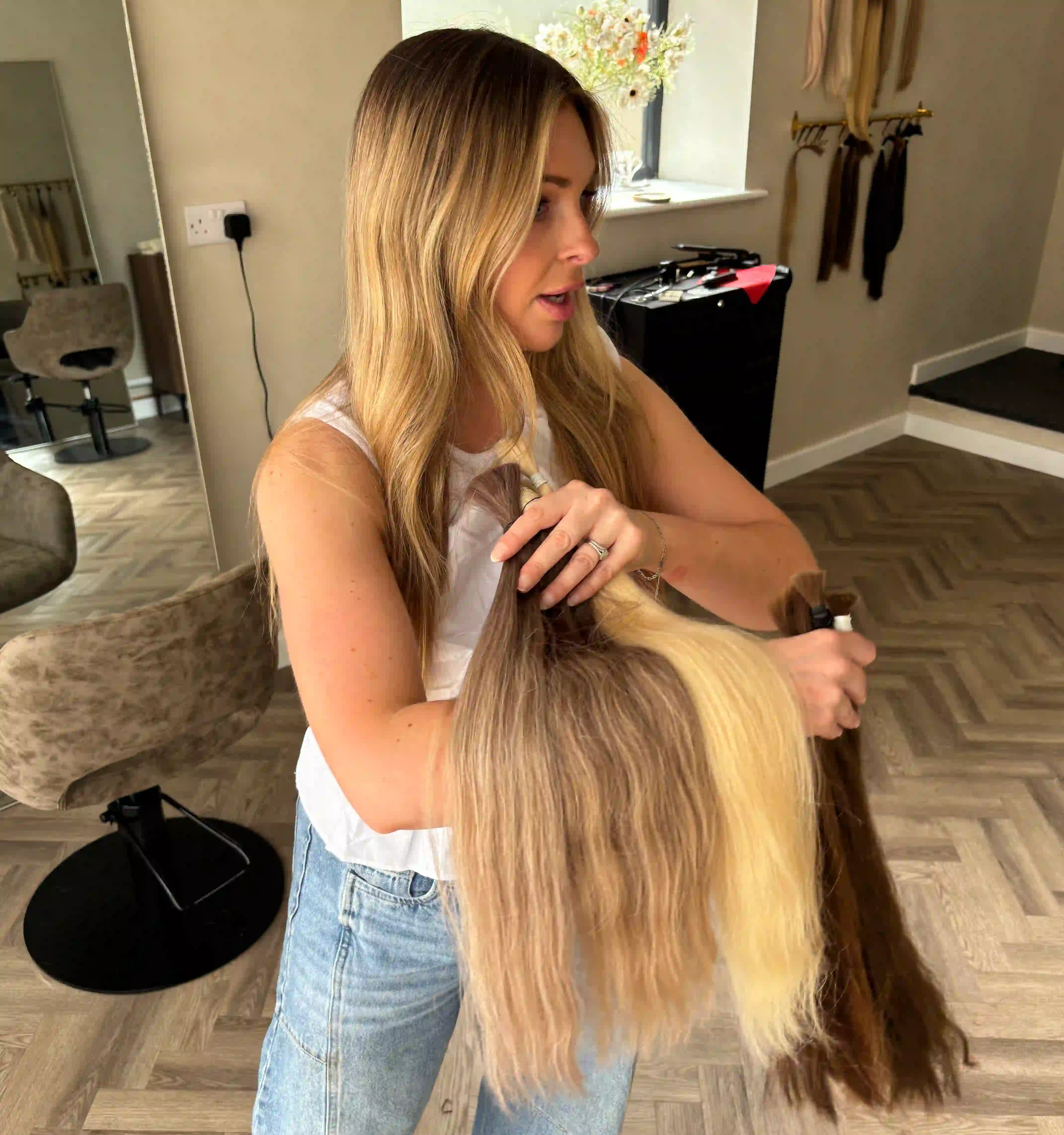 Professional hair extension specialist at work in FAKE salon North England