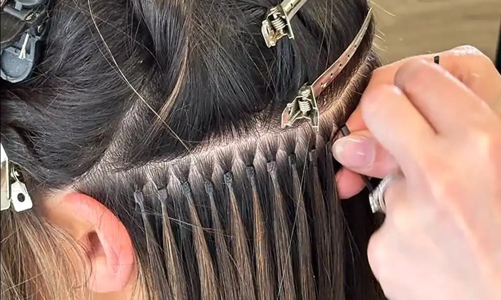 A model having micro ring hair extensions fitted in-salon