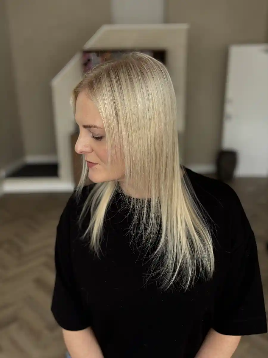 Carly's hair before keratin bond extensions, showing fine texture and lack of volume.