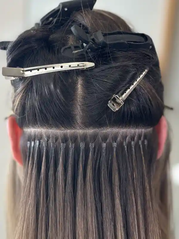Professional micro ring hair extensions fitting process showing damage-free attachment method Professional micro ring hair extensions fitting process showing damage-free attachment method